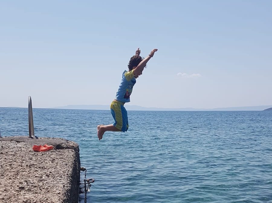 A boy jumping into the sea