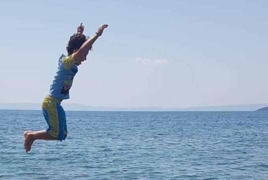 A boy jumping into the sea