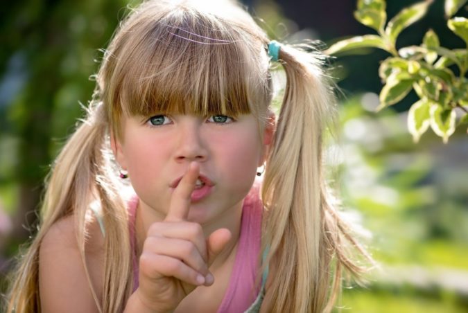 Girl making shush sign